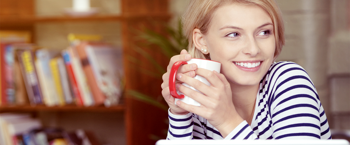Female military spouse, relaxing with a cup of coffee.