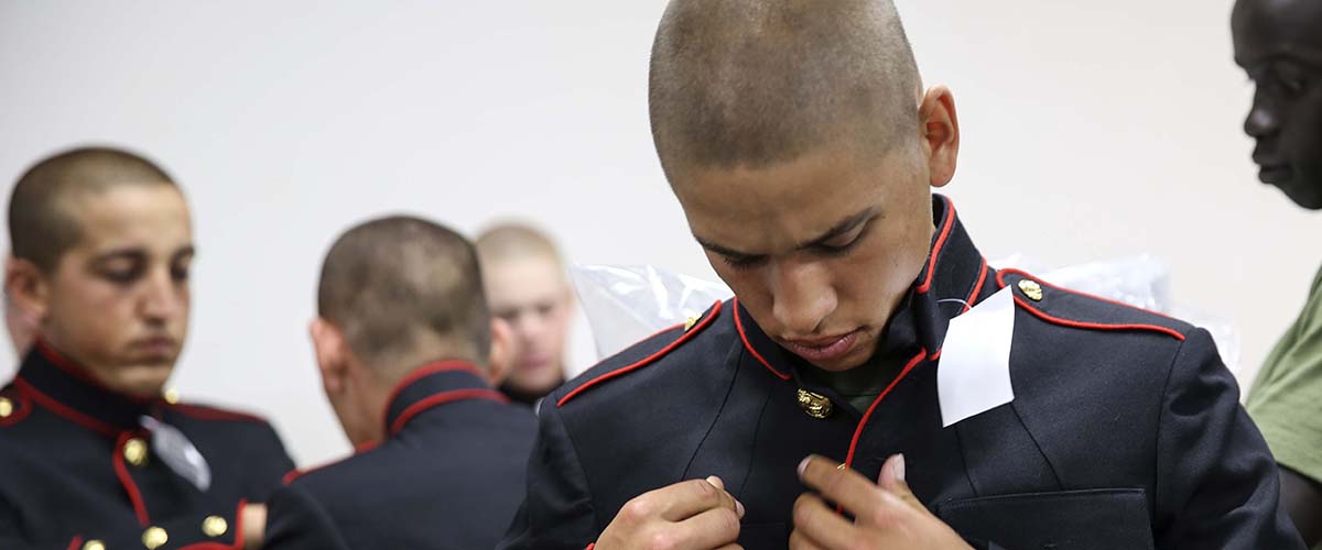 USMC Marines getting fitted for dress blue uniforms.