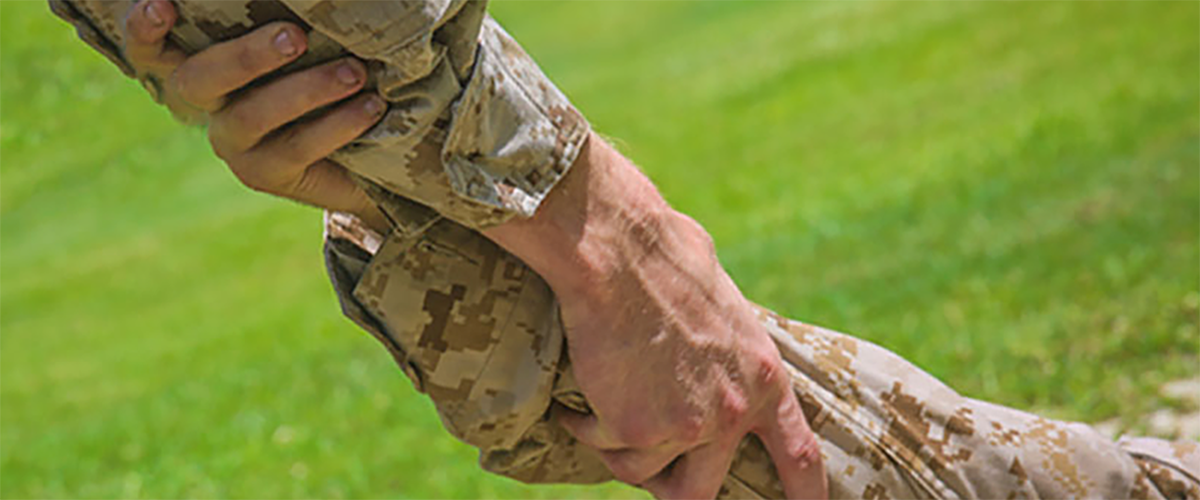 One Marine lending a helping hand to another Marine.