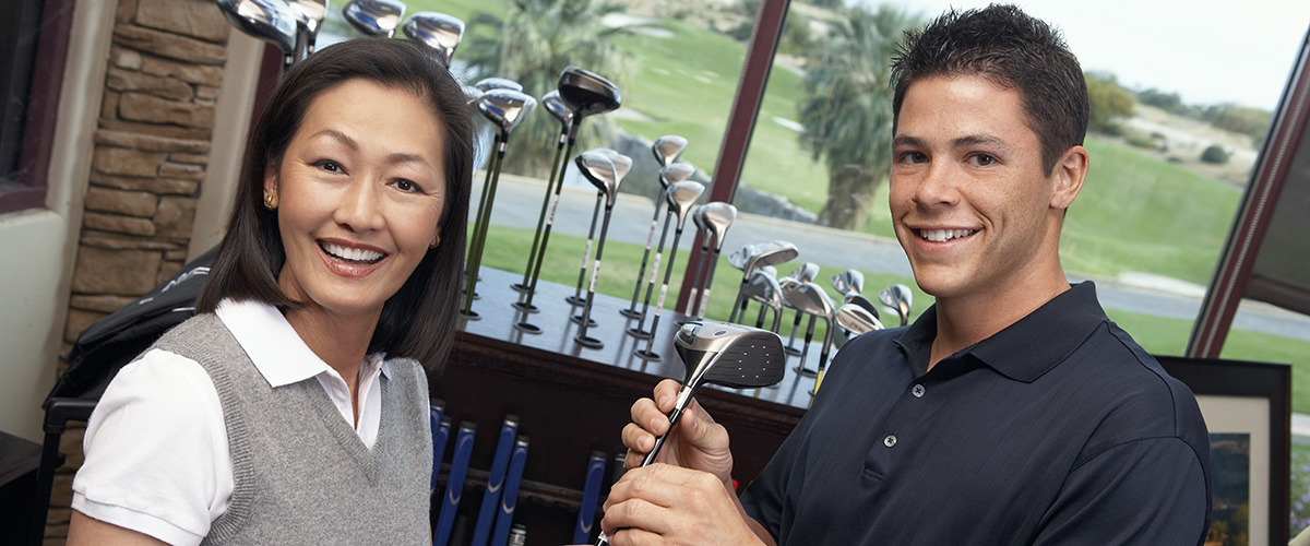 Image of a woman and a man shopping in a golf shop/store.