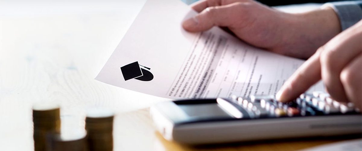 Close up image of a man's hand holding tuition assistance application.