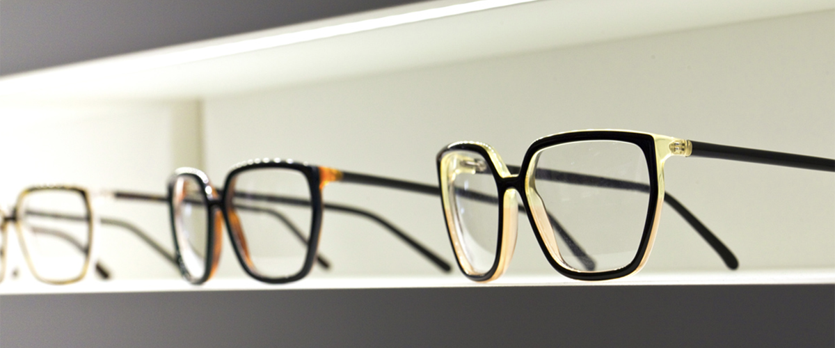 Image of eve glass frames on a store display shelf.